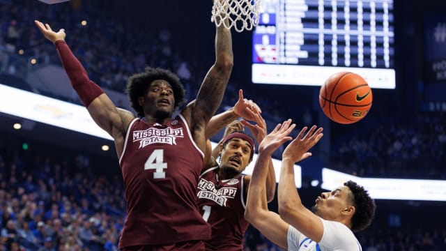 Mississippi State Bulldogs forwards Cameron Matthews (4) and Tolu Smith (1) go after a rebound against Kentucky Wildcats forward Tre Mitchell (4) during the first half at Rupp Arena at Central Bank Center.